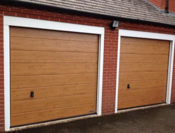 Two Hormann insulated sectional doors in Winchester Oak